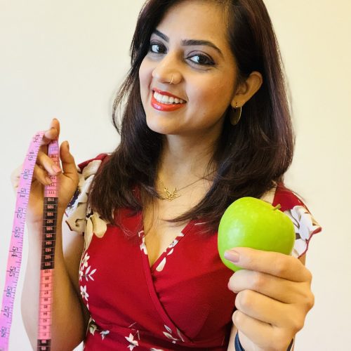 Me holding apple & meas tape