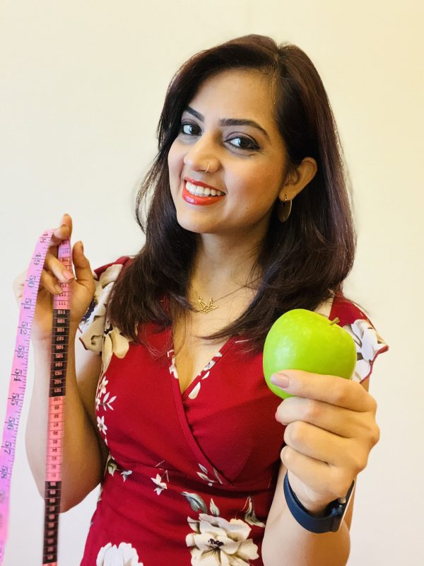 Me holding apple & meas tape